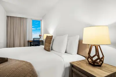 a hotel room with a bed and a lamp at 1 Bedroom Private Residence at Roney Palace -1129 in Miami Beach