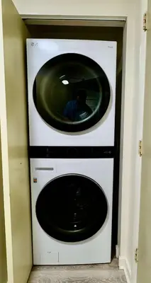 a washer and dryer with a mirror on top of it at Cocktails & Coffee with bay & city view balconies in Miami