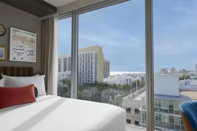 a hotel room with a bed and a large window at Hyatt Centric South Beach Miami in Miami Beach