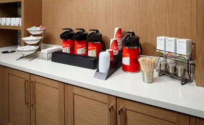 a counter with a bunch of bottles ofadobeadobeadobeadobeadobeadobeadobeadobe at Hyatt Place Miami Airport East in Miami