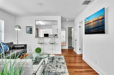 a living room with a couch and a table at Dream Hollywood Beach Retreat With Jacuzzi and Fire Pit in Dania Beach