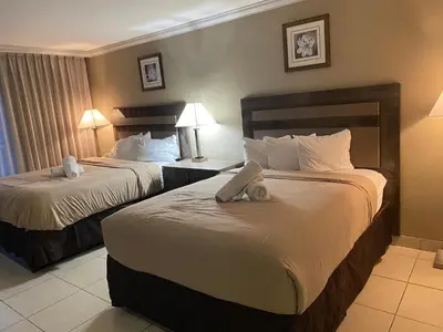 two beds in a hotel room with towels on them at All you need around you in Sunny Isles Beach