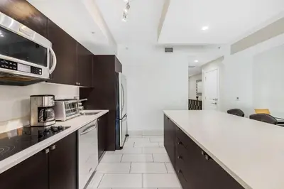 a kitchen with a white counter top and a stove top oven at Exclusive Doral Villa with Luxury Amenities in Miami