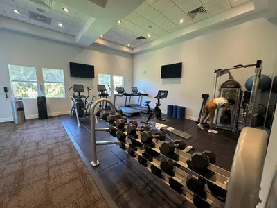a man working out in a gym with weights at Exclusive Doral Villa with Luxury Amenities in Miami