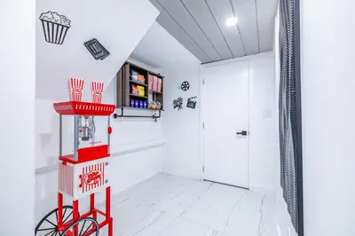 a red basketball hoop in a white room with a door at The Glow House w Cinema, Disco, Pool, BBQ, 9 beds in Ives Estates