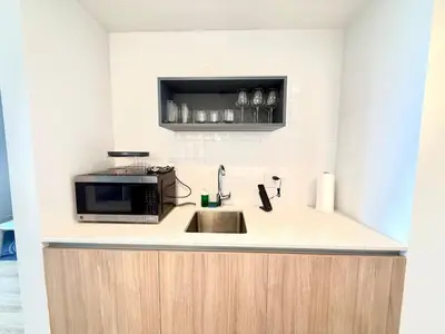 a kitchen with a sink and a microwave at 2 bedroom Stylish Condo Downtown Pool Gym spa in Miami