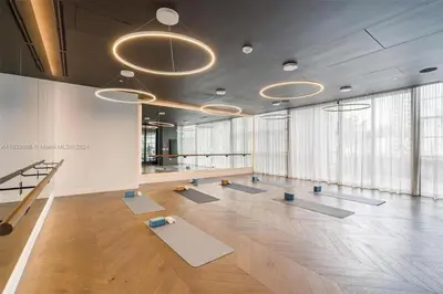 a large room with mats on the floor and large windows at 2 bedroom Stylish Condo Downtown Pool Gym spa in Miami