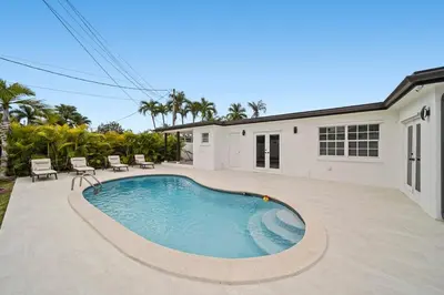 a swimming pool in the backyard of a house at Miami Oasis- Pool & Game Fun in Miami