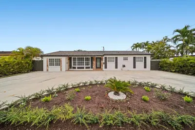 a house with a driveway and a garage at Miami Oasis- Pool & Game Fun in Miami