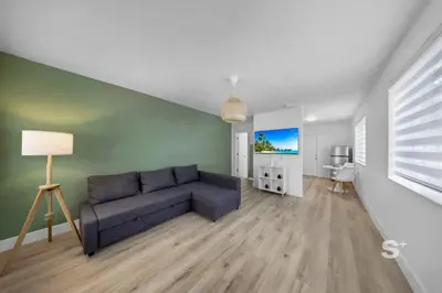 a living room with a blue couch in a room at Stylish 1-BD Apt in Miami Gym, BBQ, Free Parking in Miami