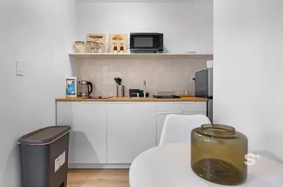 a small kitchen with a table and a trash can at Modern Studio in Miami Gym, BBQ, Free Parking in Miami