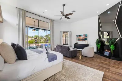 a bedroom with a bed and a living room at Spacious home wpool tennis court in Sunrise