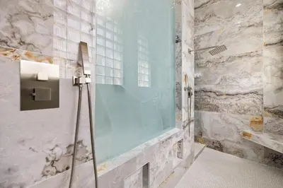 a shower with a glass door in a bathroom at Spacious home wpool tennis court in Sunrise