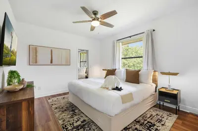 a white bedroom with a bed and a ceiling fan at Spacious home wpool tennis court in Sunrise