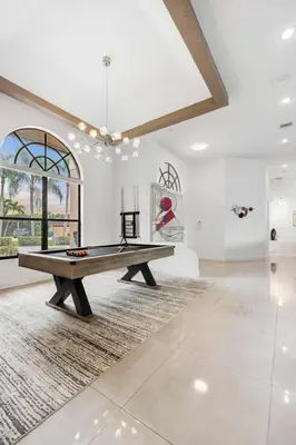 a large room with a ping pong table in it at Spacious home wpool tennis court in Sunrise