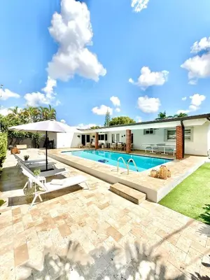 a swimming pool in the backyard of a house at Villa Miami Oasis and Heated Pool in University Park