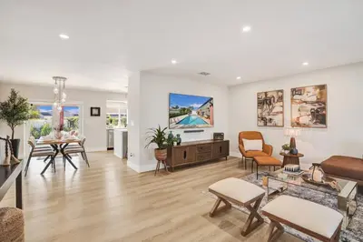 a living room with white walls and wooden floors at Villa Miami Oasis and Heated Pool in University Park