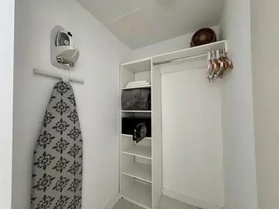 a closet with a tie hanging on a wall at 1BR on Miami Beach with Beach Service & Near Mall in Hallandale Beach