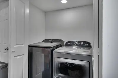 a small kitchen with a stove and a refrigerator at Waterfront Bungalow Heated Pool Pineapple Key in Fort Lauderdale