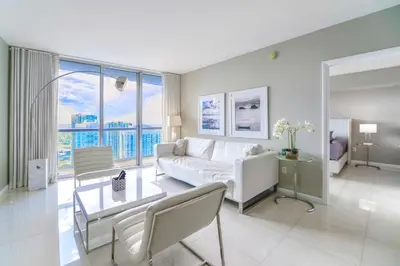 a living room with a white couch and a table at Panoramic City Views From 45th Floor Brickell Condo in Miami