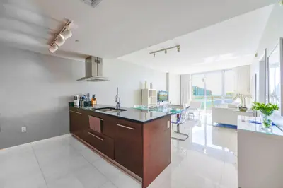 a large kitchen with a large island in a room at Panoramic City Views From 45th Floor Brickell Condo in Miami