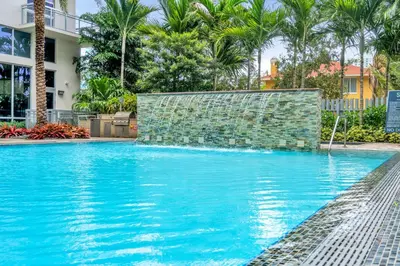 a swimming pool with blue water and palm trees at Luxury 2BR with City Views on Biscayne Blvd in Miami