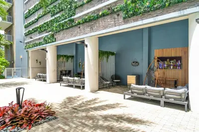 a patio with a group of beds on a building at Luxury 2BR with City Views on Biscayne Blvd in Miami