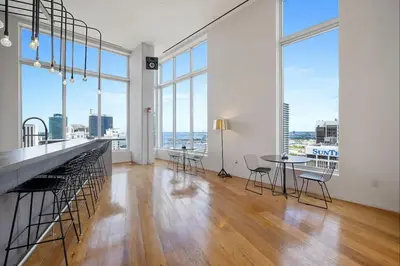 an empty room with a table and chairs and large windows at Pop Art Sunlit Apartment Prime Miami Pool Free Parking in Miami