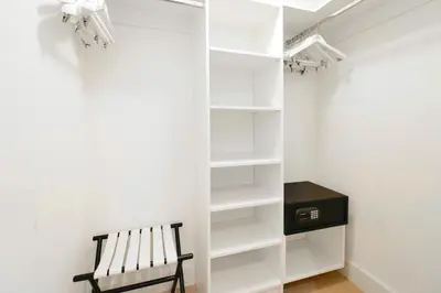 a walk in closet with a bench and a desk at Live The Perfect Vacations in a Condo From The High in Hollywood