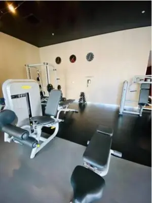 a gym with chairs and machines in a room at Studio Beach Apmt 2 Full Q Beds, Amazing View in Hallandale Beach
