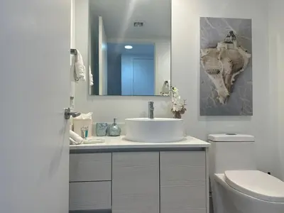 a bathroom with a sink and a toilet and a mirror at Beautiful Studio in Hallandale with Beach & Pool in Hallandale Beach
