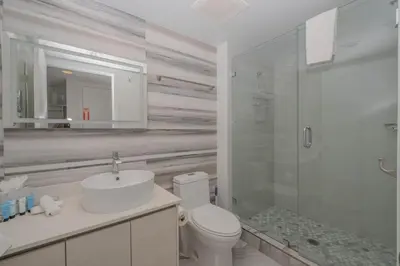 a bathroom with a toilet and a sink and a shower at Amazing 2B 2B Luxury Beach Apmt in Hallandale Beach