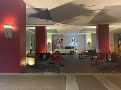 a lobby with a car parked in a building at Ocean views pool gym and more in Hallandale Beach
