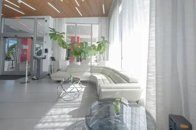 a living room with a couch and a table at 2B 2B Beachfront Pool Gym and Restaurant in Hallandale Beach