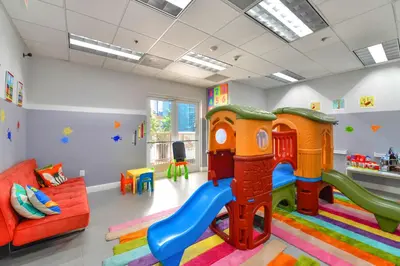 a childrens play room with a slide and a couch at Sky High Living with Incredible Views in Miami