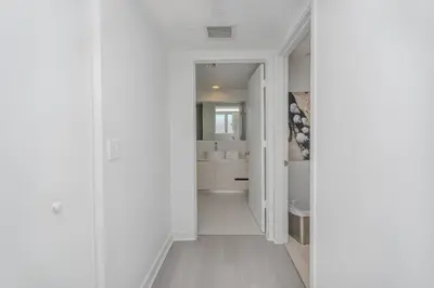 a hallway with a bathroom with white walls at 2B 2B Relax in Miami Beach and Luxury services in Hallandale Beach