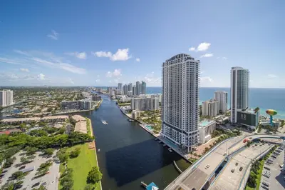 an aerial view of a city with a river and buildings at 2B 2B Relax in Miami Beach and Luxury services in Hallandale Beach