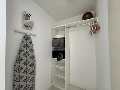 a closet with a tie hanging on a wall at Hallandale Beach Apmt 1B 1B Beach & Pool Service in Hallandale Beach