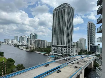 a bridge over a river in a city with buildings at Your Miami retreat beach pool and Aventura Mall in Hallandale Beach