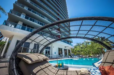 a resort with a swimming pool and a building at Perfect getaway beach pool and Aventura Mall 2209 in Hallandale Beach