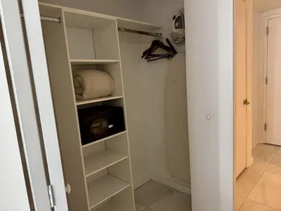 a walk in closet with white shelves and a door at Getaway in Miami 2B 2B beachfront near Aventura 3003 in Hallandale Beach