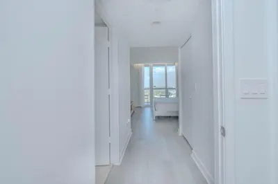 a white hallway with a couch and a window at Your Paradise in Miami Beach Gym and Pool 2b 2b 1507 in Hallandale Beach