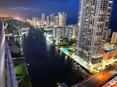 a city at night with a river and buildings at Your Paradise in Miami Beach Gym and Pool 2b 2b 1507 in Hallandale Beach