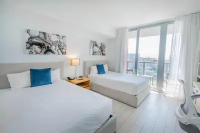 a bedroom with two beds and a large window at 2B 2B Beautiful Apt in Hallandale Beach with Beach Service 2605 in Hallandale Beach
