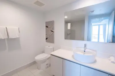 a white bathroom with a sink and a toilet at 2B 2B Beautiful Apt in Hallandale Beach with Beach Service 2605 in Hallandale Beach