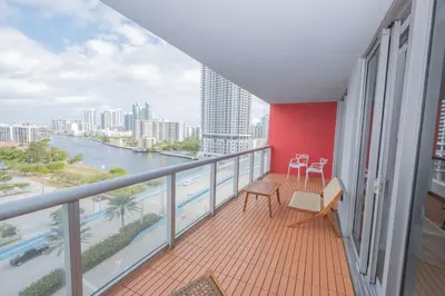 a balcony with a view of a river and buildings at Miami Apt with Gym Beach Service Pool on the water 2607 in Hallandale Beach