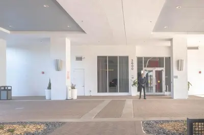 a man in a suit standing outside of a building at Relax in Miami 2B 2B Beach and Pool with Drinks in Hallandale Beach