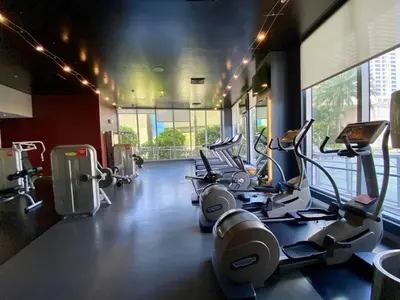 a gym with cardio machines and a large window at Enjoy Miami Beach Pool and Restaurant 2B 2B 2007 in Hallandale Beach