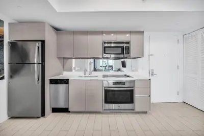 a kitchen with stainless steel appliances and a refrigerator at Enjoy Miami Beach Pool and Restaurant 2B 2B 2007 in Hallandale Beach
