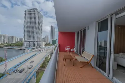 a balcony of a building with a view of a city at Luxury Miami Apartment Beach and Poolside drinks 2308 in Hallandale Beach